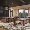 large room with pool table  seating and tv